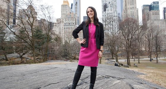 Survivor contestant Eliza Orlins at Manhattan DA race blushing in a pink outfit.